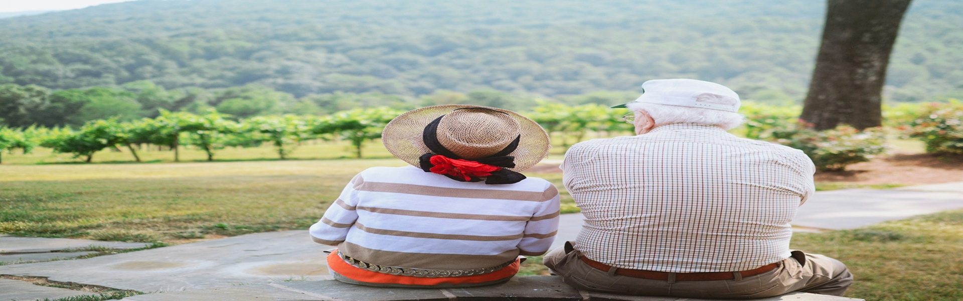 Older couple sitting together outdoors enjoying a peaceful view, representing healthy aging with internal medicine care in Shenandoah and The Woodlands TX