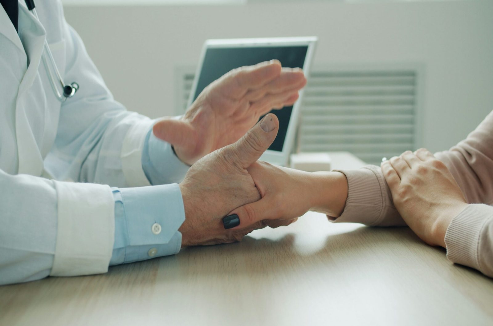 Internal medicine physician consulting with a patient during an office visit in Shenandoah and The Woodlands TX